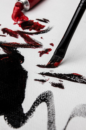 Brushing Red and Black Acrylic on Canvasの写真素材