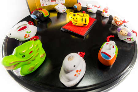 Twelve animals to decorate on New Year's Day in Japan (the central animal is the main character of the year) The letters written behind represent the names of twelve kinds of animals.の写真素材