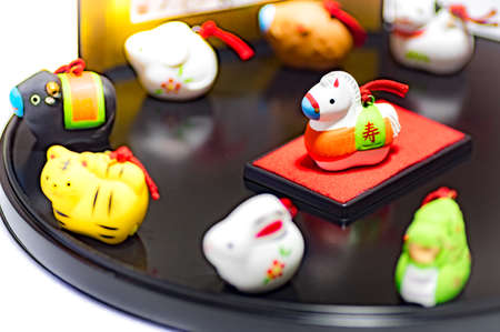 Twelve animals to decorate on New Year's Day in Japan (the central animal is the main character of the year) The letters written behind represent the names of twelve kinds of animals.の写真素材