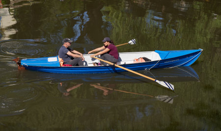 Unidentified people rowing a boat in Prague, Czech Republic.の写真素材