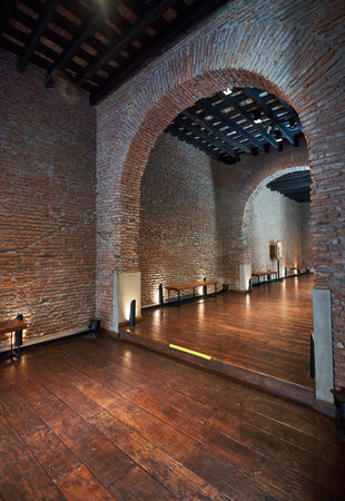 Interior view of an old building with brick walls and wooden floorの写真素材