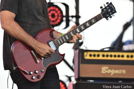Guitarist on stage during a live concert at a music festivalの写真素材