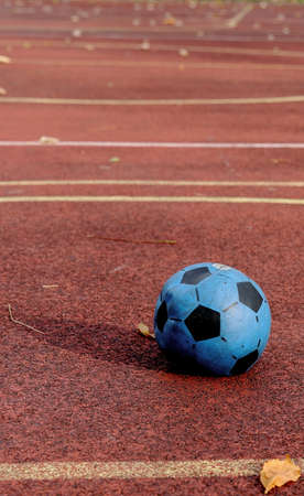 Old blue boll in empty autumn pitchの写真素材