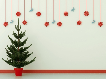 Green tree against a blue wall with Christmas decorationsの写真素材