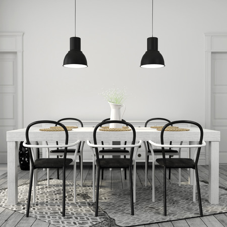 Interior of dining area with a large white table with black chairsの写真素材
