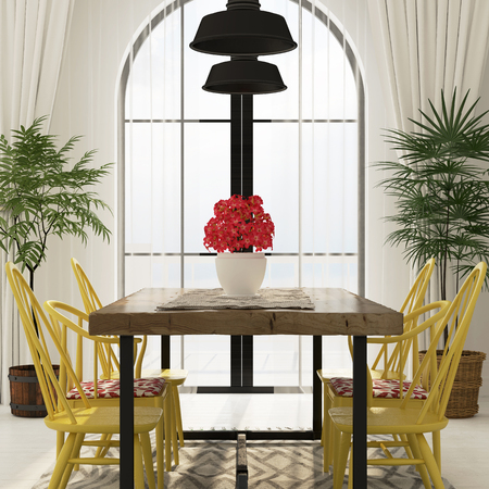 Interior of the dining area with a large wooden table and bright yellow chairs that make the summer moodの写真素材