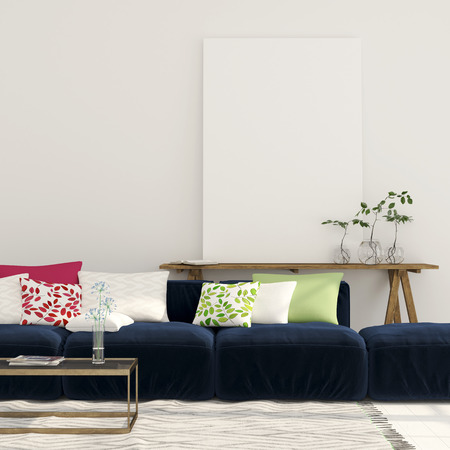 Wide blue sofa with colorful pillows and a wooden console with a large canvas on itの写真素材
