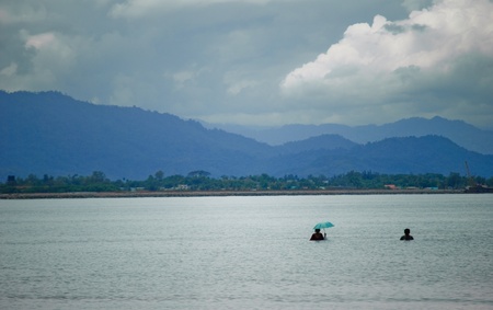 beach swimming with umbrellaの写真素材