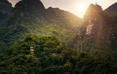 cable car along the mountain under sunsetの写真素材
