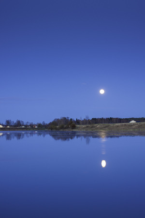 The moon reflected in the still water of the river PyhÃ¤joki  Notice the amount of light in the night  Thatの写真素材