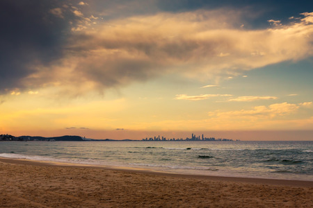 The skyline of the city of Gold Coast can be seen in the horizon from a beach in Coolangatta, QLD, Australia. A place well worth visiting.の写真素材