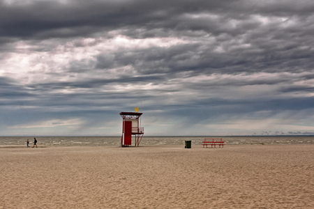 The rain is coming to the beach at Pärnu, Estonia. The people are leaving for shelter.の写真素材