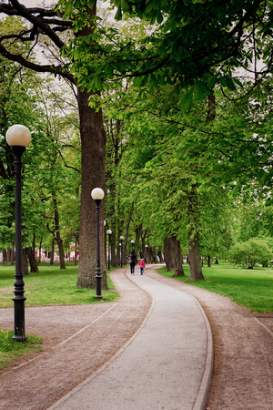 Mother and daughter are walking through the Kadriorg park in Tallinn, Estonia. The old park is almost like the living room of the capitol of Estonia.の写真素材