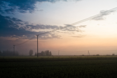 The sun sets beautifully on a summer evening in the rural Finland. The nights are very white in the middle of the summer in these parts of the country.の写真素材
