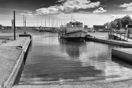 An old wooden boat is waiting for passangers at the harbour of Kotka in Finland. These boats used to take people to the nearby islands.の写真素材