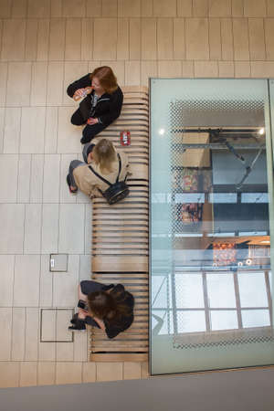 Above view of people having a break while shopping at the market. The market is actually below them under the floor.の写真素材
