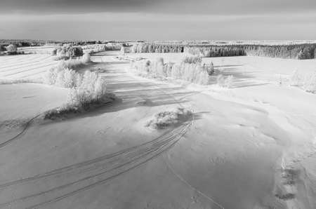 The snow on the river ice is decorated with snow mobile tracks. The frozen river is an excellent track for high speed snow mobile racing.の写真素材