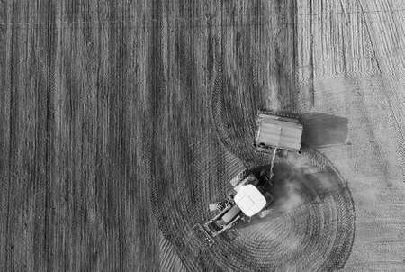 The farmer is creating interesting patterns on the dry fields while sowing.の写真素材