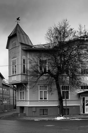 An old building at the Kadriorg area of Tallinn, Estonia. A man is peeking from the front door of the house.の写真素材