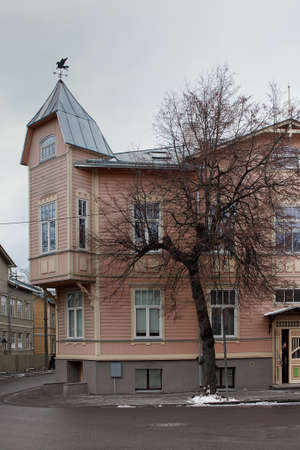 An old building at the Kadriorg area of Tallinn, Estonia. A man is peeking from the front door of the house.の写真素材