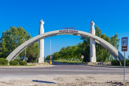 Moldavia, Chisinau may 2018: Arch of the entrance to the territory of the famous grapes and wine production plant cricova. Inscription "regatul vinului" in Romanian. Means Kingdom of wineの写真素材