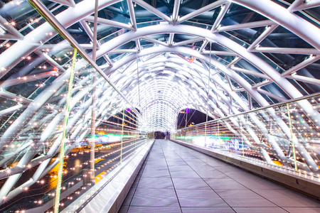 The Bridge of Peace is a bow-shaped pedestrian bridge, a steal and glass construction illuminated with numerous LEDs, over the Kura River in downtown Tbilisi, capital of Georgia. Night photoの写真素材