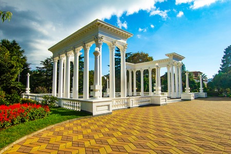 Beautiful view to the elegant white Greek - style colonnades serves as the entrance to the city beach, Batumi, Georgia. Batumi is a stylish resort located in a convenient natural Black Sea bayの写真素材