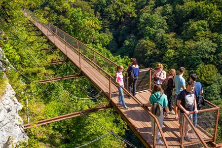 Zeda-gordi, Georgia - September 19, 2018: People Walking and taking photos On the hiking trail on Territory national Park Okatse near View point on Narrow Suspension Bridge.のeditorial素材