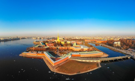 Beautifull aerial view of the Petropavlovsky fortress in sunny spring day. Golden tall spire of famous Peter and Paul Cathedral on the blue sky background. Historical centre of St. Petersburg, Russia.のeditorial素材