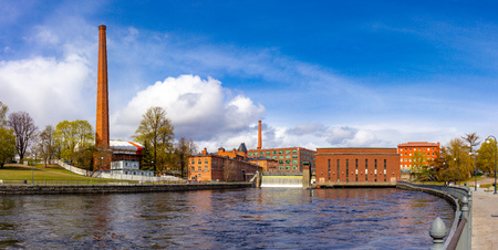 Beautifull panoramic view at Water dam of old Hydroelectric power station on Tammerkoski river and old traditional industrial buildings on a sunny summer day. Center of downtown Tampere, Finland.の写真素材