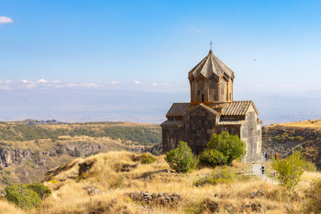 Famous view to ancient Vahramashen church of the 11th century, located near destroyed Amberd fortress in sunny summer day. Cliff with Arkashian River deep in canyon. Aragatsotn, Armeniaの写真素材