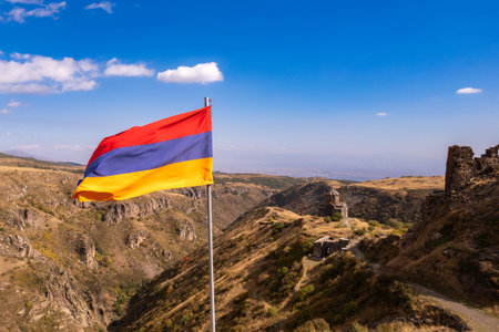 Aerial drone view to flag of Armenia and famous Vahramashen Church of the 11th century, near Amberd...