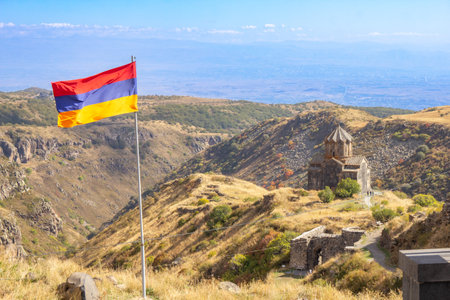 Aerial drone view to flag of Armenia and famous Vahramashen Church of the 11th century, near Amberd...