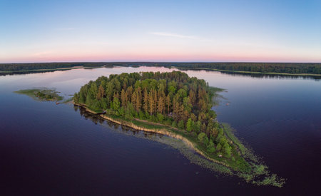 Aerial top view to island in summer evening during white nights. Vuoksa lake river and channels system leaking in Finland and Russia flowing into Ladoga. Romashki village, Leningrad region, karelia.の写真素材