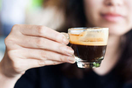 close up woman handing coffee cup espressoの写真素材