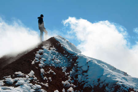 Tourist stands on the summit of Avacha volcanoの写真素材