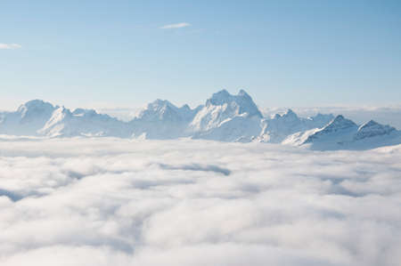 Mountain ridge sticking out of the clouds