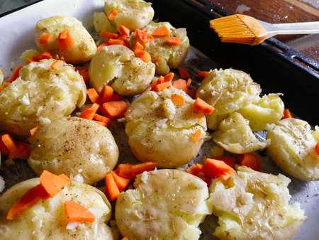 Young potatoes with carrots before baking in the ovenの写真素材