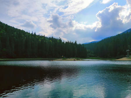 Carpathian Lake Synevyr reflects a dark forest