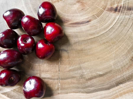 Cherry berries lie on a wooden boardの写真素材
