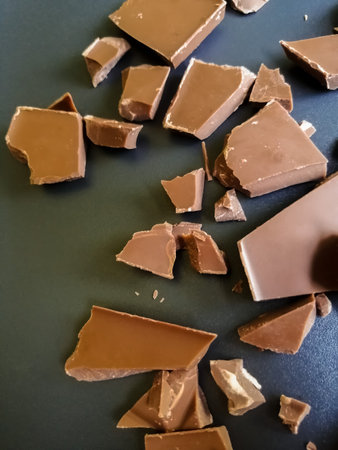 Pieces of broken chocolate on a dark backgroundの写真素材