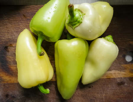 Sweet bell pepper on a wooden plank, with tailsの写真素材