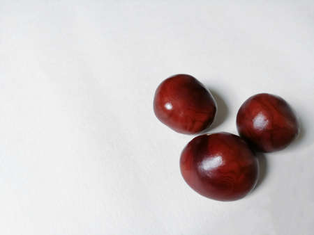 Three chestnuts spre, together on a white backgroundの写真素材