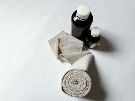 Two jars with anti-mesh and elastic bandage - first aid for bruisesの写真素材