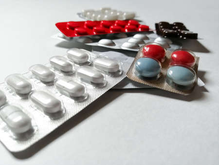 Colored packages of tablets on a white backgroundの写真素材