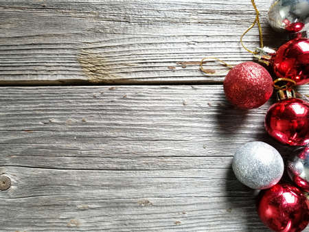 On wooden boards on the side are red and silver Christmas balls.の写真素材