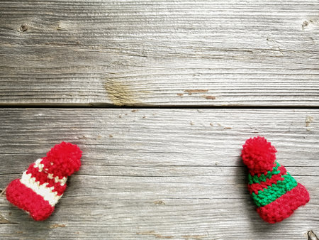 Beautiful miniature handmade hats on wooden boards. Winter motifs.の写真素材