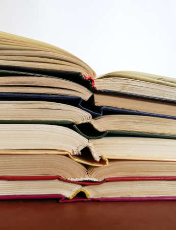Books on top of each other in front of a singing background.の写真素材