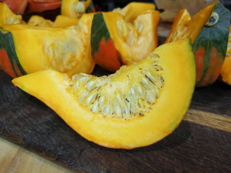 Autumn gifts of nature. A piece of chopped orange pumpkin.の写真素材
