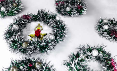 Miniature Christmas wreaths are empty and embroidered on a white background.の写真素材